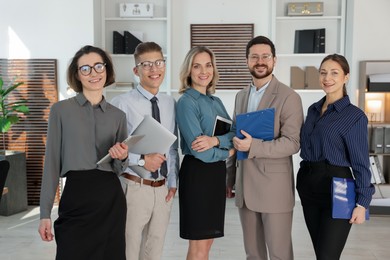 Photo of Portrait of happy coworkers in formal clothes indoors