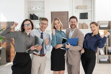 Photo of Portrait of happy coworkers in formal clothes indoors