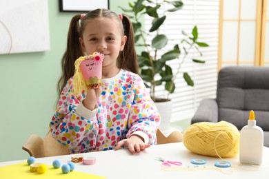 Photo of Little girl with handmade toy at home. Child creativity and craft