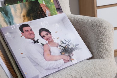 Photo of Canvas with different printed photos on armchair, closeup