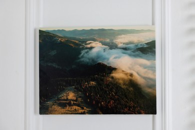 Photo of Canvas with printed photo of mountains on white wall indoors