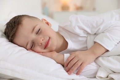 Photo of Bedtime. Cute boy sleeping in comfortable bed