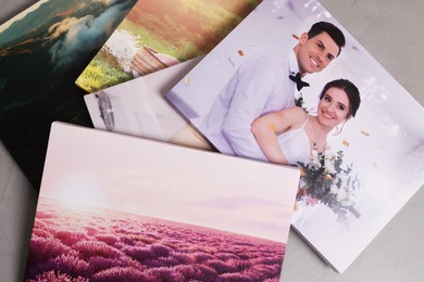 Photo of Canvases with printed photos on grey textured background, above view