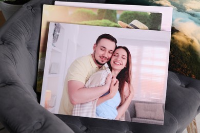 Photo of Canvas with different printed photos on armchair indoors, closeup