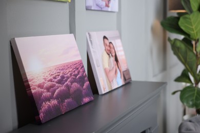 Photo of Canvas with printed photos on table indoors