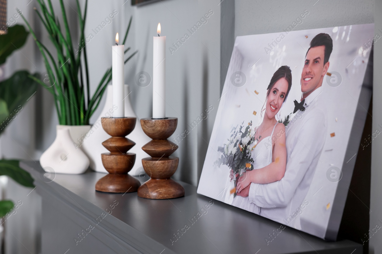 Photo of Canvas with printed photo and decor on table indoors