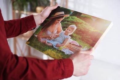 Photo of Canvas print. Woman with photo at home, closeup