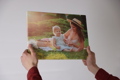 Photo of Canvas print. Woman with photo on light background, closeup