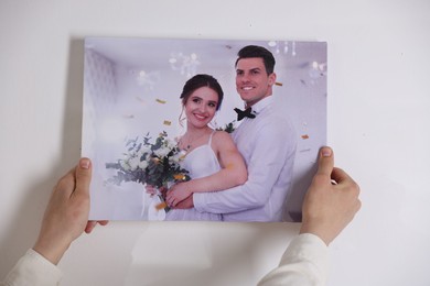 Photo of Canvas print. Woman with photo on light background, closeup