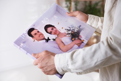 Photo of Canvas print. Woman with photo at home, closeup