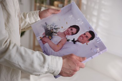 Photo of Canvas print. Woman with photo at home, closeup