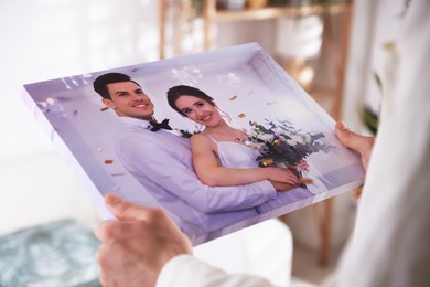 Photo of Canvas print. Woman with photo at home, closeup