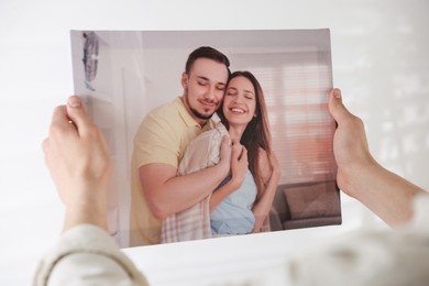 Photo of Canvas print. Woman with photo on light background, closeup