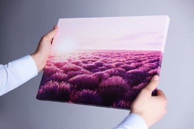 Photo of Canvas print. Woman with photo on light background, closeup