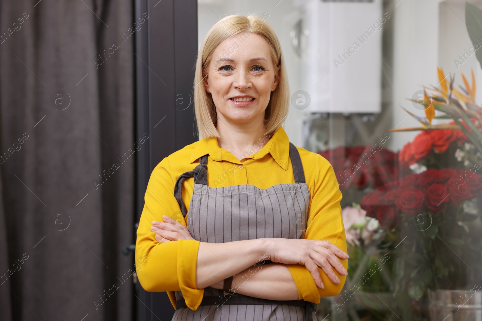 Photo of Business owner with crossed arms in her flower shop