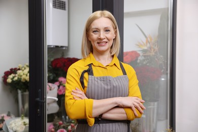 Photo of Business owner with crossed arms in her flower shop