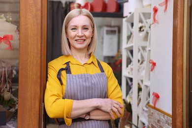 Photo of Business owner at door of her flower shop