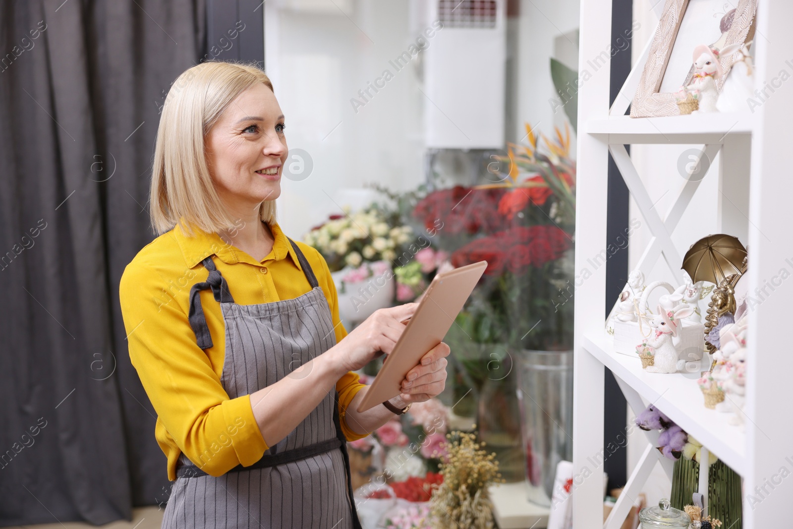 Photo of Business owner with tablet in her flower shop