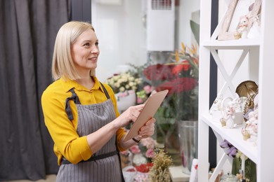 Photo of Business owner with tablet in her flower shop