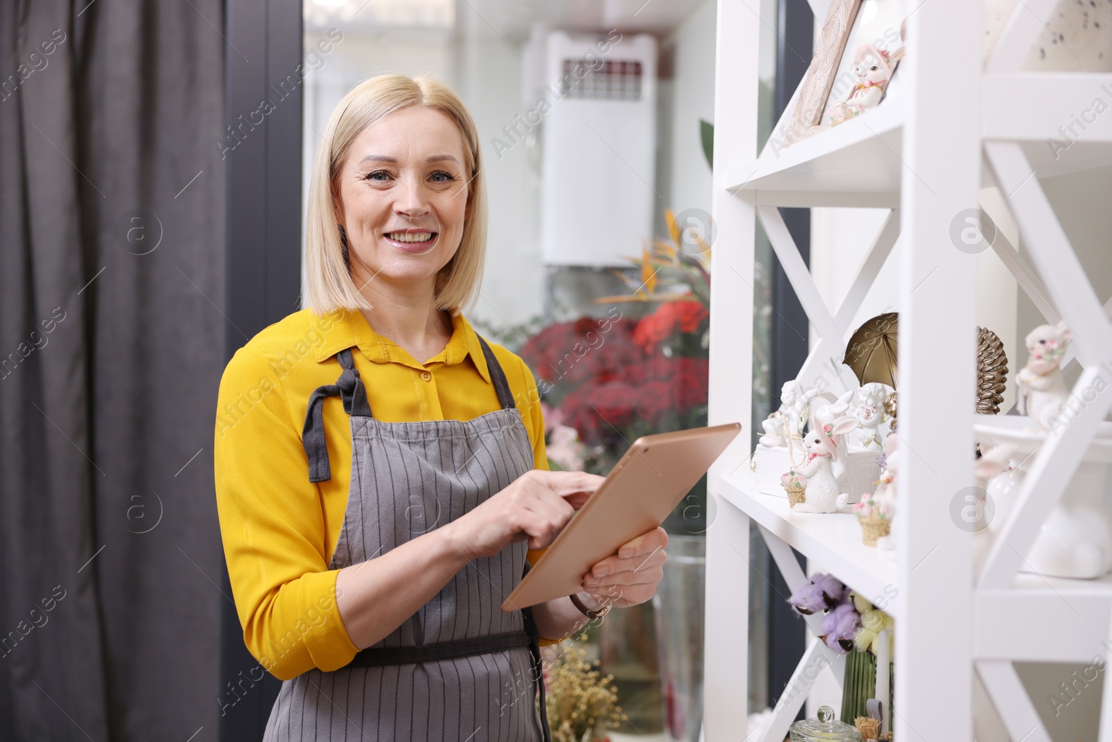 Photo of Business owner with tablet in her flower shop