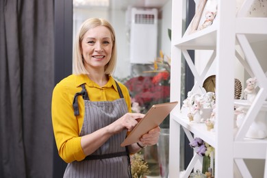 Photo of Business owner with tablet in her flower shop