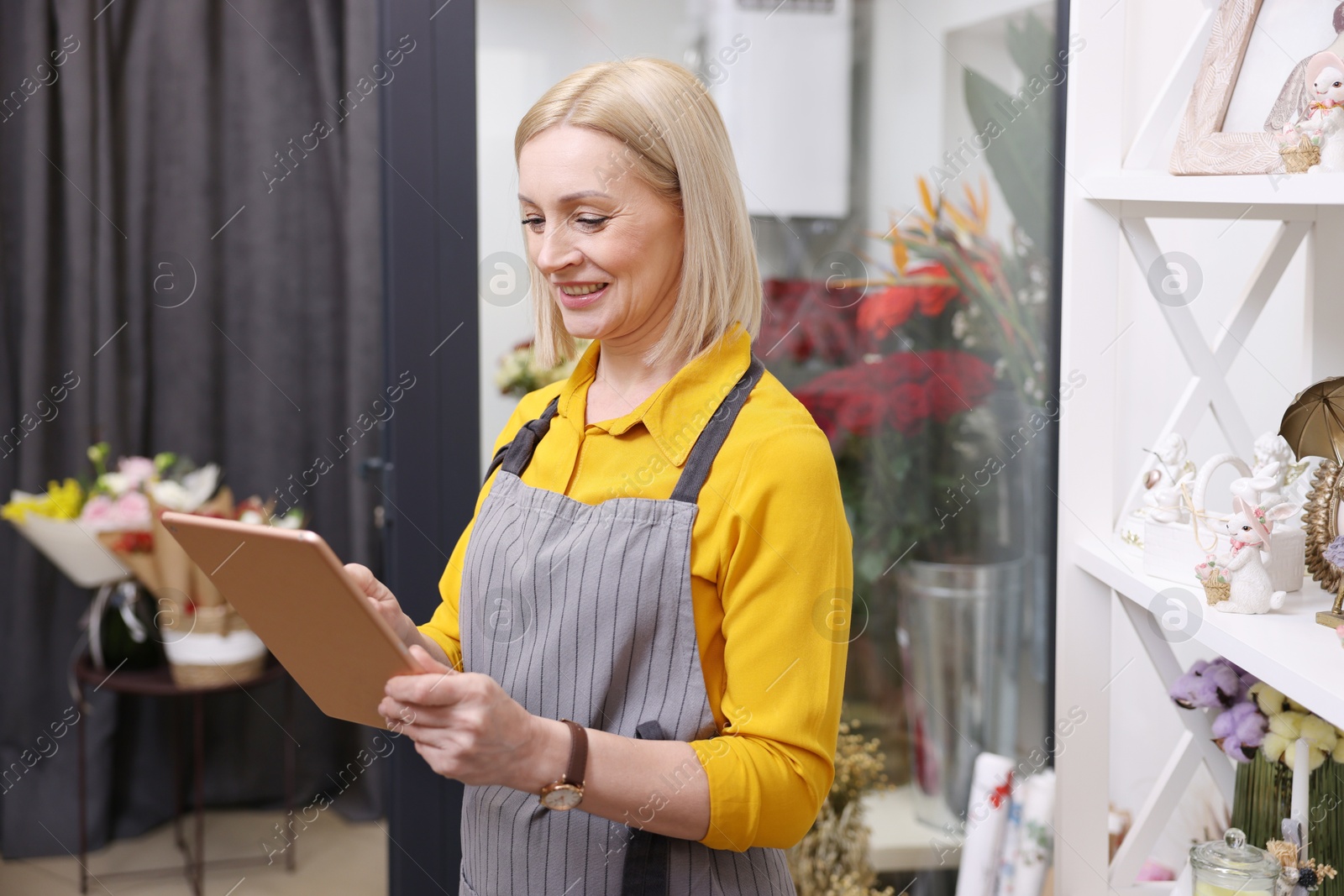 Photo of Business owner with tablet in her flower shop