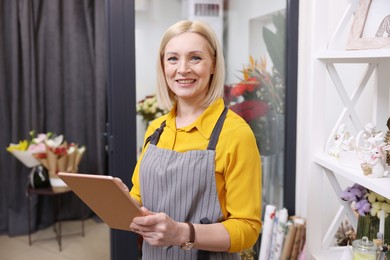 Photo of Business owner with tablet in her flower shop