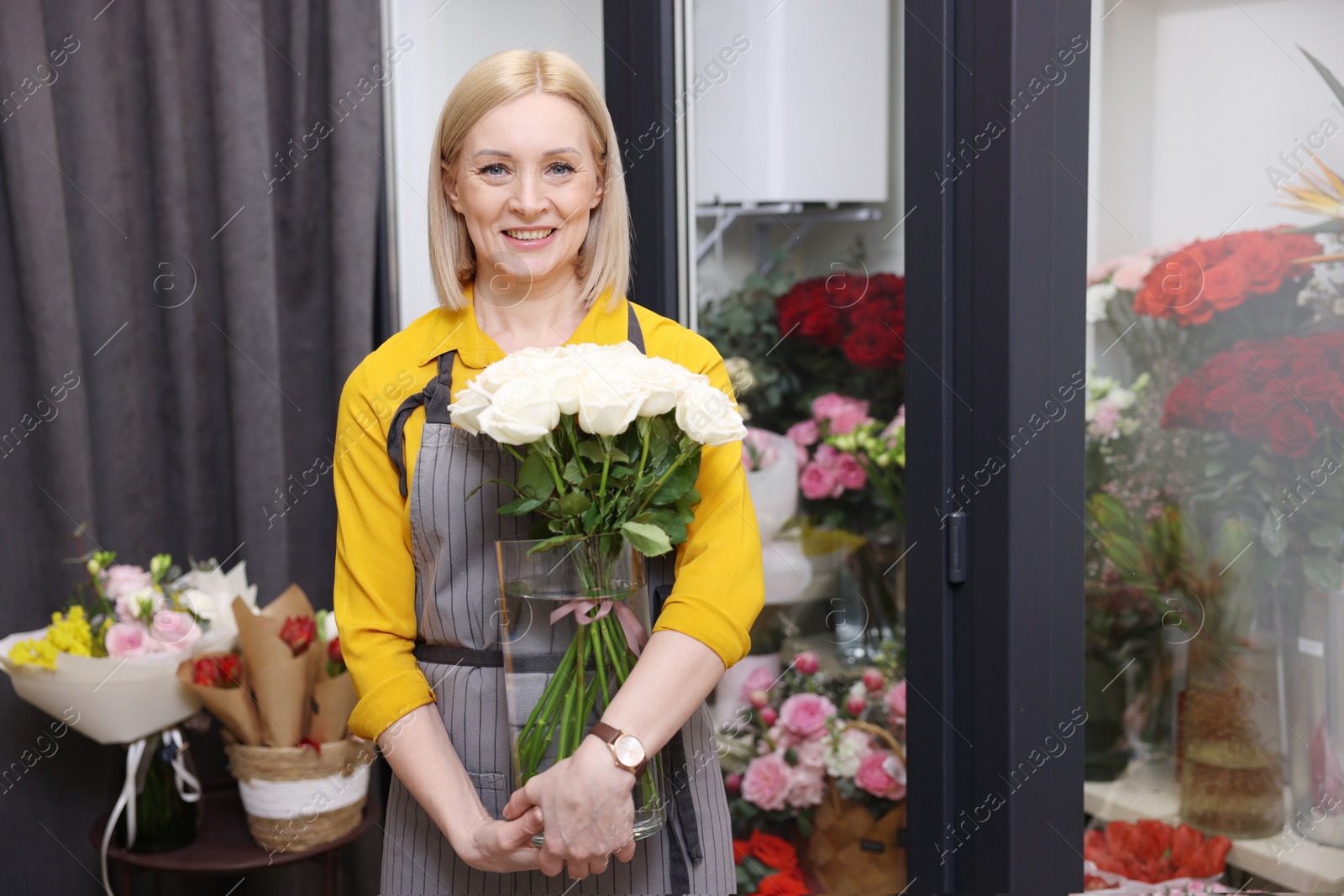 Photo of Business owner with beautiful roses in her flower shop