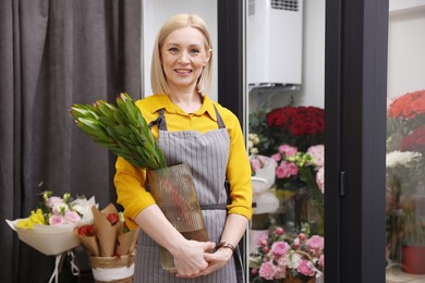 Photo of Business owner with green plant in her flower shop