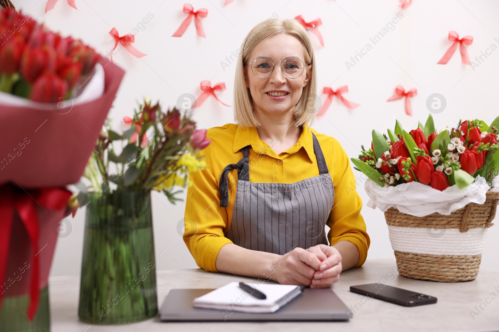 Photo of Business owner at table in her flower shop