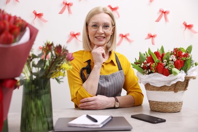 Photo of Business owner at table in her flower shop