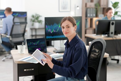 Photo of Stock exchange. Woman working at desk in office