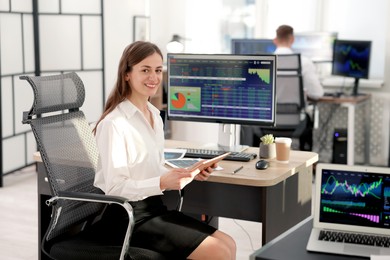 Photo of Stock exchange. Woman working at desk in office