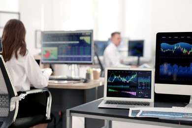 Photo of Stock exchange. Woman working at desk in office