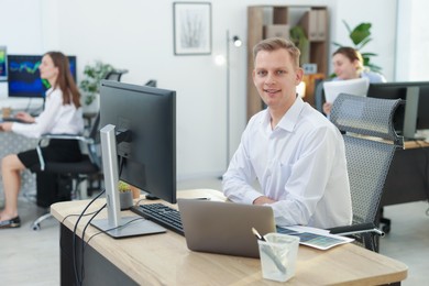 Photo of Stock exchange. Man working at desk in office