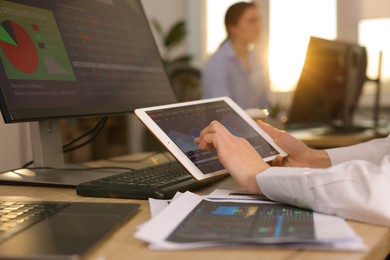 Photo of Stock exchange. Woman working at desk in office, closeup