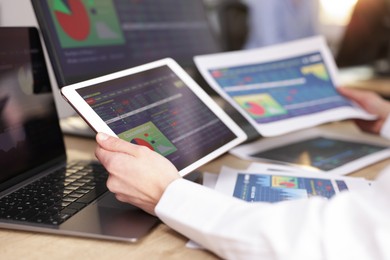 Photo of Stock exchange. Woman working at desk in office, closeup