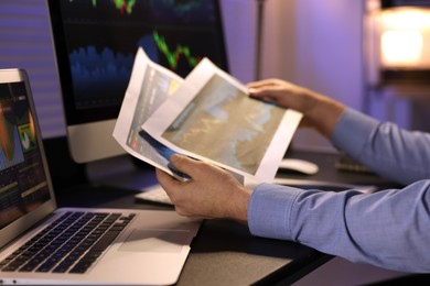 Photo of Stock exchange. Man working in office at night, closeup