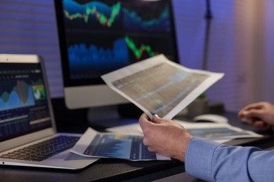 Photo of Stock exchange. Man working in office at night, closeup