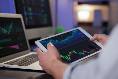 Photo of Stock exchange. Man working in office at night, closeup