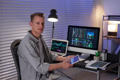 Photo of Stock exchange. Man working in office at night