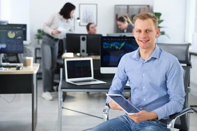 Photo of Stock exchange. Man working at desk in office