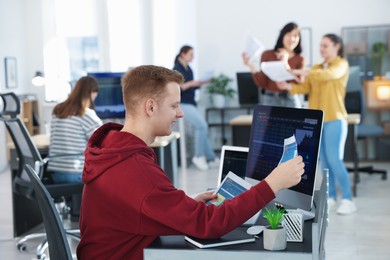 Photo of Stock exchange. Man working at desk in office