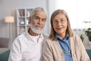 Photo of Portrait of happy elderly couple at home