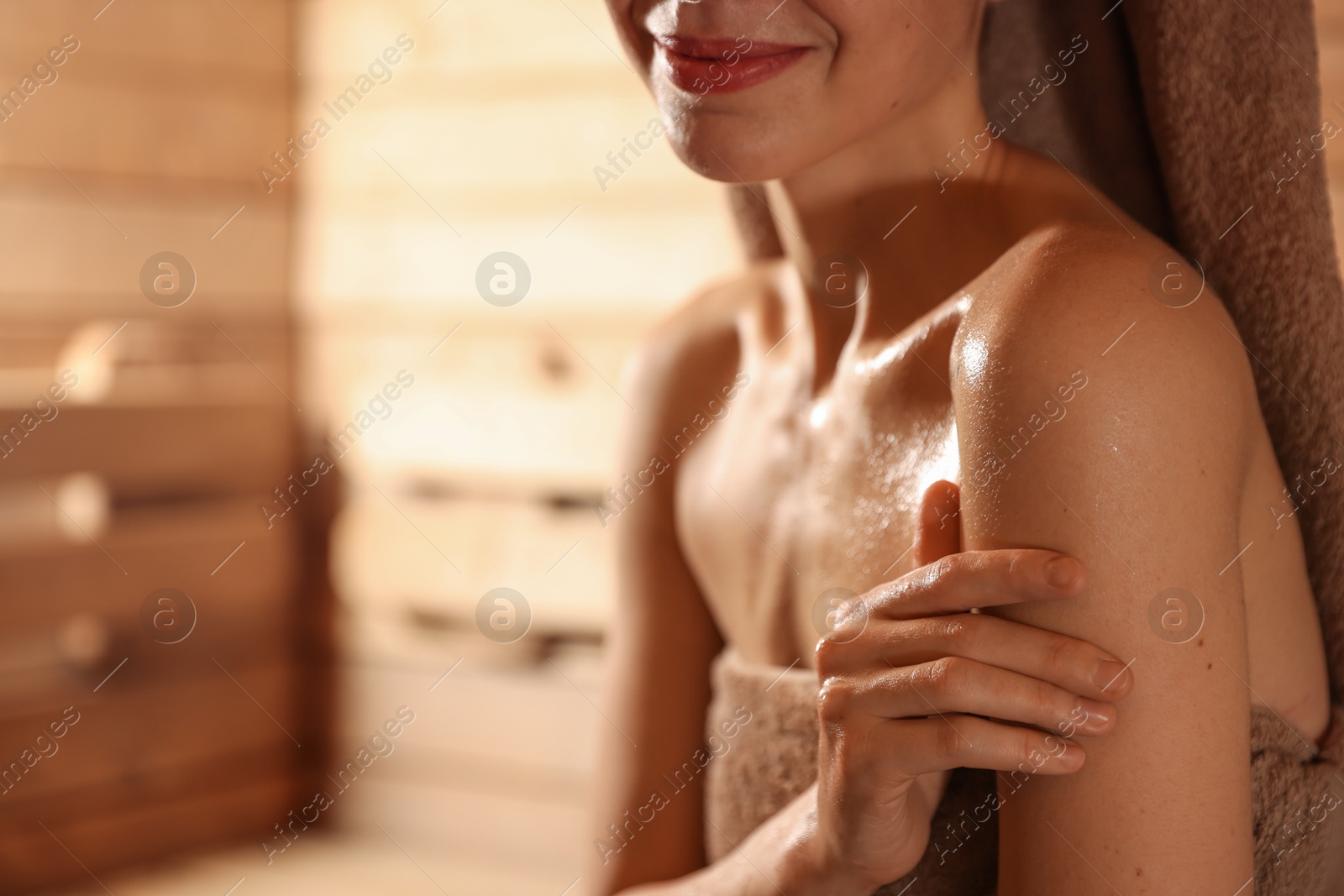 Photo of Beautiful woman in hot sauna, closeup. Space for text