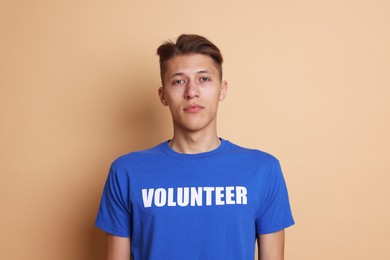 Photo of Portrait of young volunteer on beige background