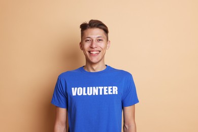 Photo of Portrait of smiling volunteer on beige background