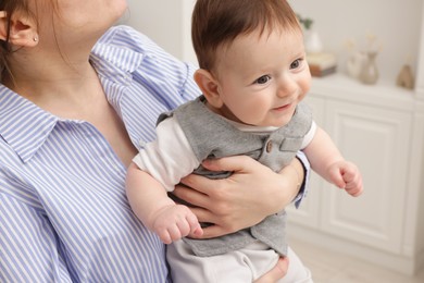 Photo of Mother holding her little baby at home, closeup