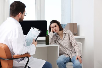 Photo of Alcoholic woman having appointment with healthcare specialist in clinic. Addiction treatment