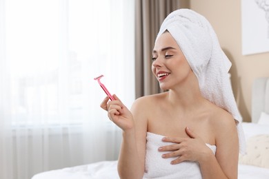 Photo of Happy woman with razor at home, space for text. Hair removal tool